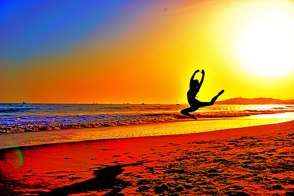 Ballerina Flying Threw the Air on Beach Sunset